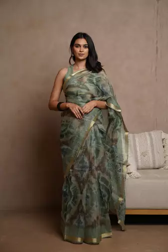 Dusty green kota doria polyester shibori print golden zari border saree