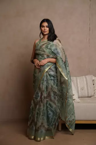 Dusty green kota doria polyester shibori print golden zari border saree