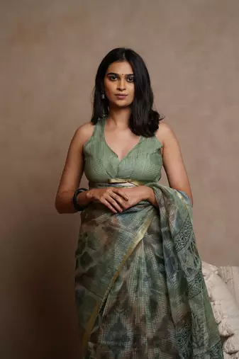 Dusty green kota doria polyester shibori print golden zari border saree
