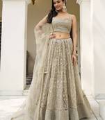 Ivory Sequins Embroidered Net Engagement Wedding Wear Lehenga Choli