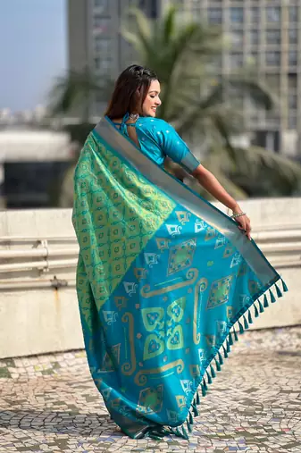 Sea green wevon meenakari ikkat patola silk blendceremonial saree