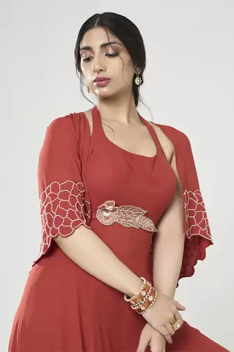 Rust orange jumpsuit with short cape