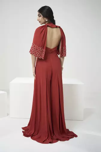 Rust orange jumpsuit with short cape