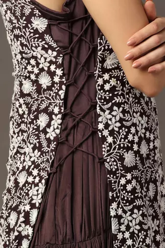 Purple tiered sleeveless anarkali gown with a white parsi straight cape
