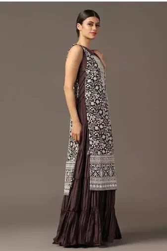 Purple tiered sleeveless anarkali gown with a white parsi straight cape