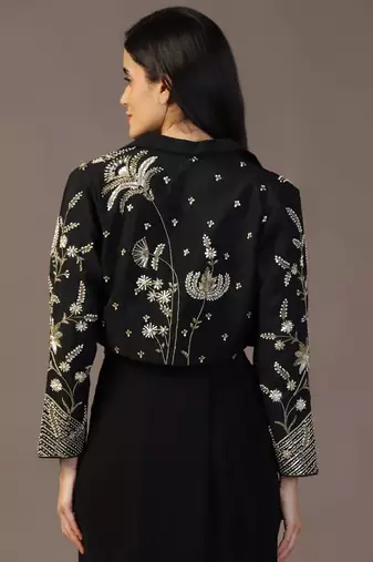 Black top with draped skirt and embroidered jacket
