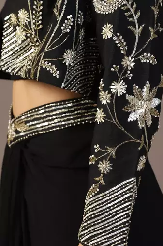 Black top with draped skirt and embroidered jacket