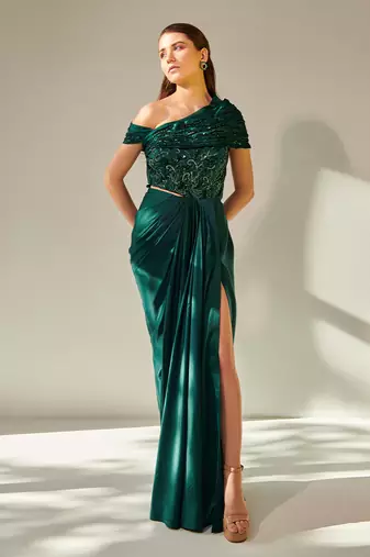 Off shoulder emerald green drape gown with waist cut out