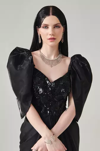 Black draped gown with voluminous sleeves