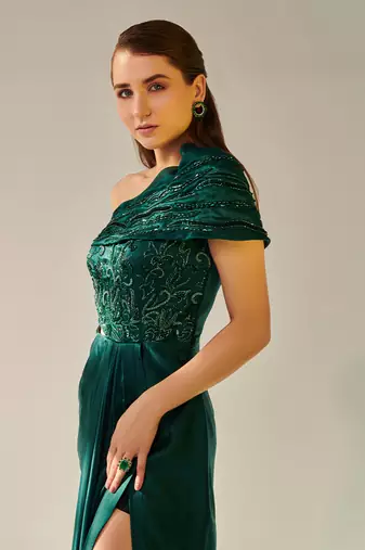 Off shoulder emerald green drape gown with waist cut out