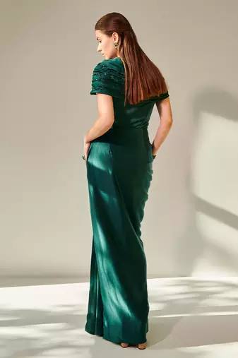 Off shoulder emerald green drape gown with waist cut out