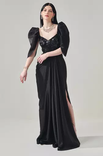 Black draped gown with voluminous sleeves