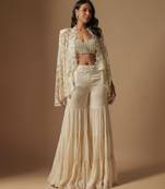 Orlique mirror work blouse paired with embroidered cape and sharara