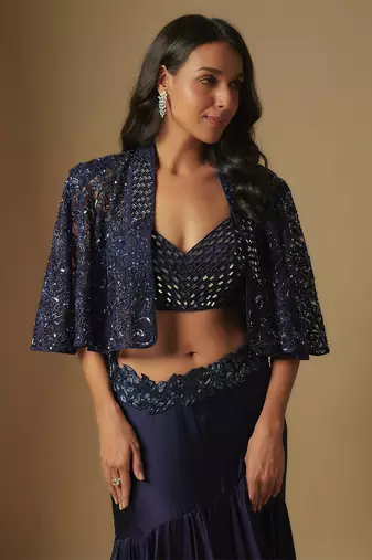 Marasu mirror work blouse paired with hand embroidered cape and ruffled skirt