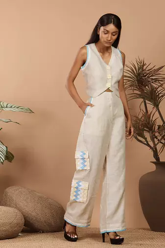 Beige crop top with medium broad pants with abstract print long jacket