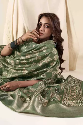 Green zari woven saree with unstitched blouse piece