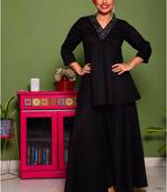 Two piece black colored suit with hand embroidered miror work flared short top paired with palazzo