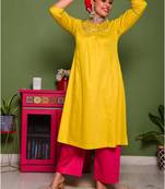 Two piece mustard colored suit with hand embroidered mirror work long kurti paired with contrast trouser
