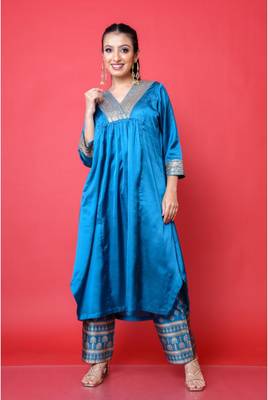 Two piece teal colored suit with sequence work paired with hand block print trouser 1