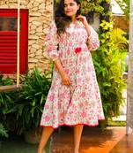 One piece pink colored flared jaipuri print cotton dress with pintucked yoke and stringed tassels.