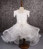 White dress with detachable drape.