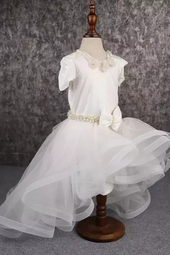 White dress with detachable drape.