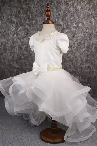 White dress with detachable drape.
