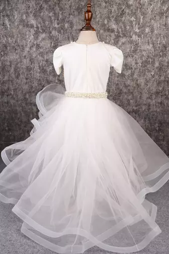 White dress with detachable drape.