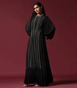 Black gown embellished with pearls and antique silver cutbeads with belt