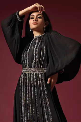 Black gown embellished with pearls and antique silver cutbeads with belt