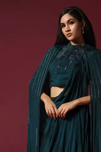 Teal green pre-draped saree with a shoulder cape