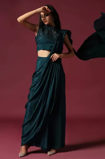 Teal green pre-draped saree with a shoulder cape