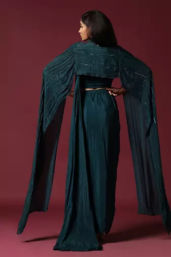 Teal green pre-draped saree with a shoulder cape