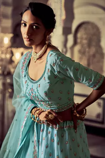 Aqua color heavy embroidered lehenga choli set.