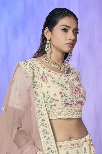white heavy work lehenga with vibrant blouse and contrast dupatta