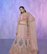 peach heavy work lehenga with vibrant blouse and contrast dupatta
