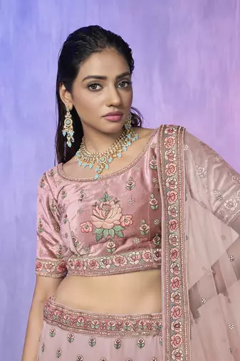 peach heavy work lehenga with vibrant blouse and contrast dupatta