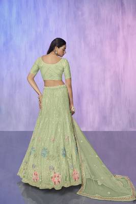 green heavy work lehenga with vibrant blouse and contrast dupatta 3