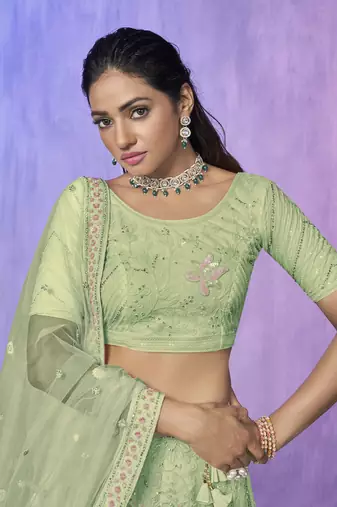 green heavy work lehenga with vibrant blouse and contrast dupatta