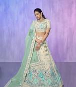 white heavy work lehenga with vibrant blouse and contrast dupatta