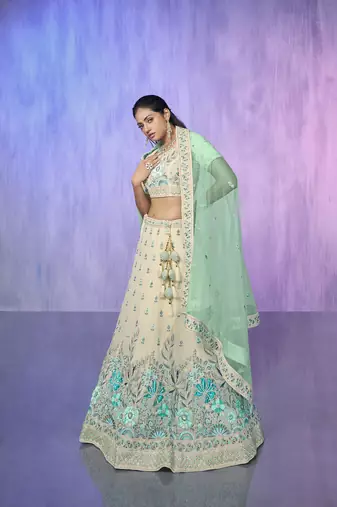 white heavy work lehenga with vibrant blouse and contrast dupatta