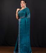 Teal blue jimmy choo saree with intricate silver embellishments and beautiful curve border