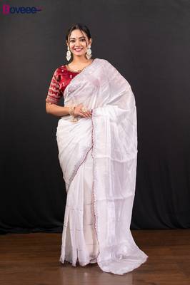 White jimmy choo saree adorned with intricate silver embellishments and a beautifully detailed border with ready blouse 1