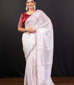White jimmy choo saree adorned with intricate silver embellishments and a beautifully detailed border with ready blouse