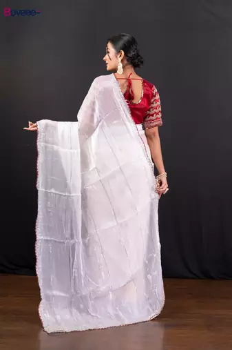 White jimmy choo saree adorned with intricate silver embellishments and a beautifully detailed border with ready blouse