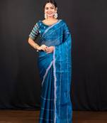 Blue jimmy choo saree adorned with intricate silver embellishments and a beautifully detailed border with ready blouse