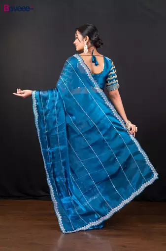 Blue jimmy choo saree adorned with intricate silver embellishments and a beautifully detailed border with ready blouse