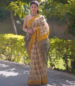 Cream saree with yellow border and black pallu