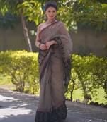 Cream kota doria saree with black stripes, black border and pallu