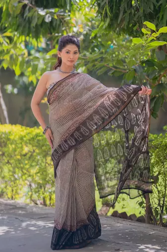 Cream kota doria saree with black stripes, black border and pallu